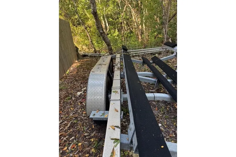  Yacht Photos Pics Trailer for 2017 Regulator 25 boat in wooded area, surrounded by leaves.