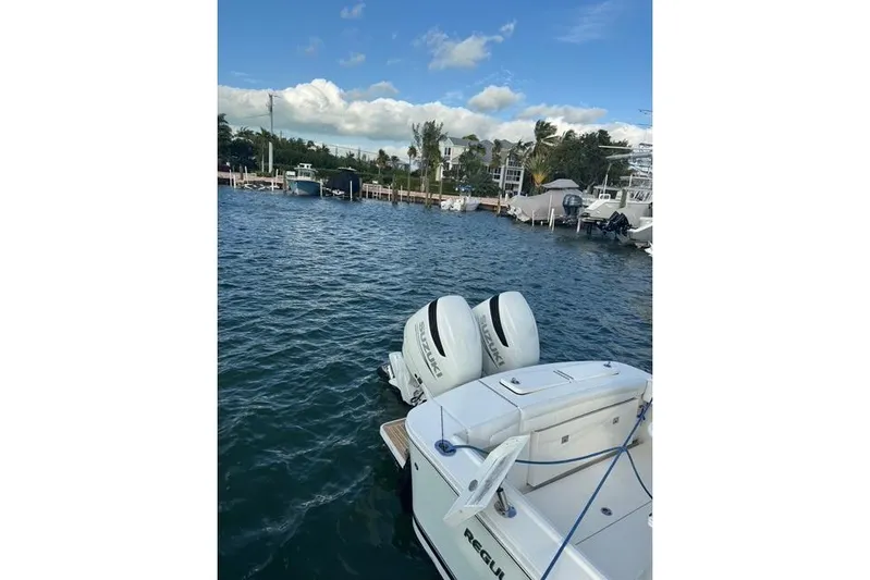  Yacht Photos Pics 2017 Regulator 25 boat with dual engines docked in a marina.