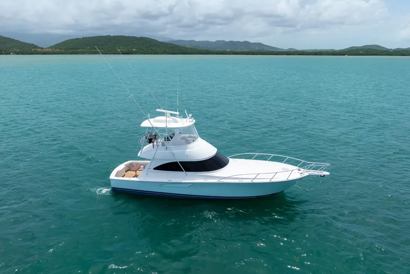 Insomnio Yacht Photos Pics 2022 Viking 48 Convertible yacht cruising on turquoise waters.