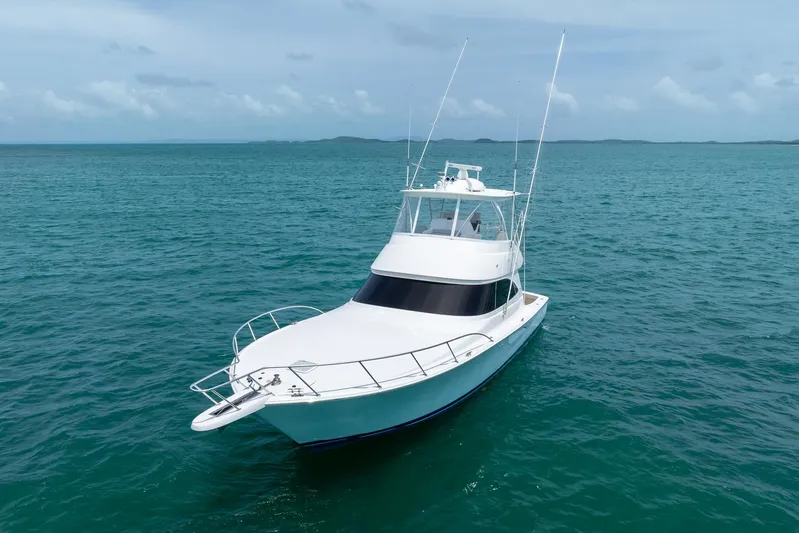 Insomnio Yacht Photos Pics 2022 Viking 48 Convertible yacht cruising on open sea under clear skies.