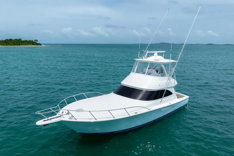 Insomnio Yacht Photos Pics 2022 Viking 48 Convertible yacht cruising on clear blue ocean waters.