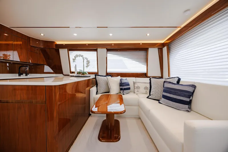 Insomnio Yacht Photos Pics Luxurious interior of 2022 Viking 48 Convertible yacht with elegant seating and wooden finishes.