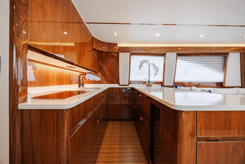Insomnio Yacht Photos Pics Luxurious kitchen interior of 2022 Viking 48 Convertible yacht with sleek wood finishes.
