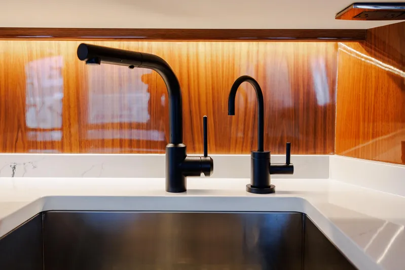 Insomnio Yacht Photos Pics Modern kitchen sink with black faucets on Viking 48 Convertible yacht, 2022 model.