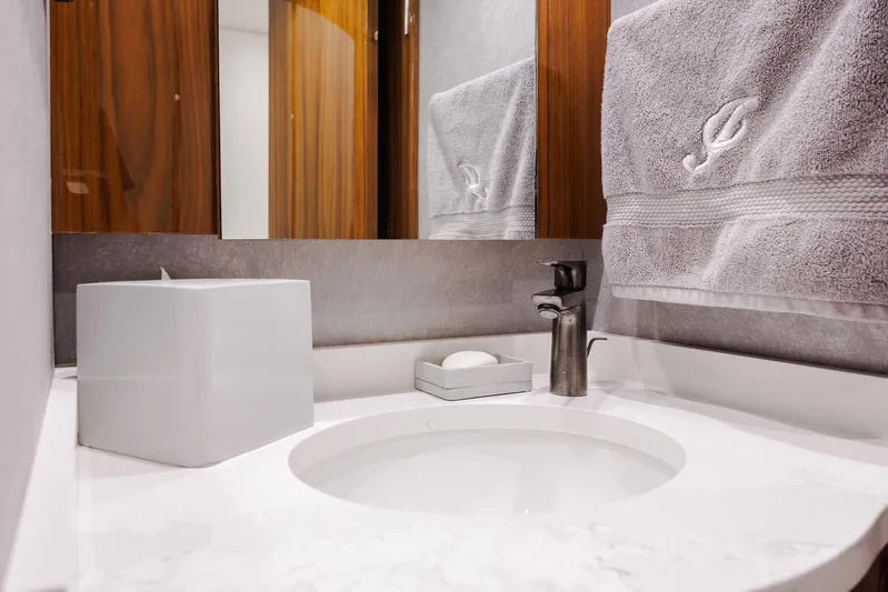 Insomnio Yacht Photos Pics Modern bathroom vanity on 2022 Viking 48 Convertible yacht with sleek faucet and elegant decor.