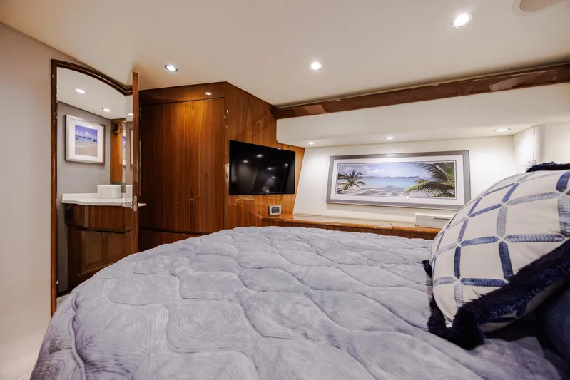 Insomnio Yacht Photos Pics Luxurious bedroom interior of 2022 Viking 48 Convertible yacht with modern decor and cozy bedding.