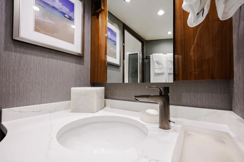 Insomnio Yacht Photos Pics Luxurious bathroom in 2022 Viking 48 Convertible yacht with modern fixtures and elegant decor.