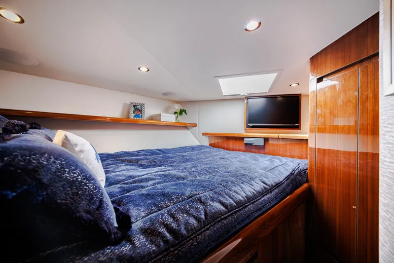 Insomnio Yacht Photos Pics Luxurious cabin interior of 2022 Viking 48 Convertible yacht with cozy bedding and TV.