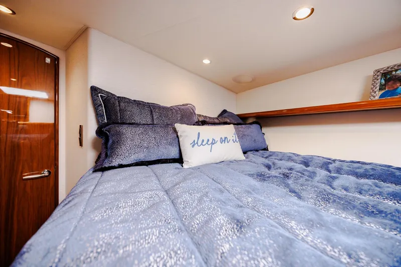 Insomnio Yacht Photos Pics Luxurious bedroom interior of 2022 Viking 48 Convertible yacht with plush bedding.