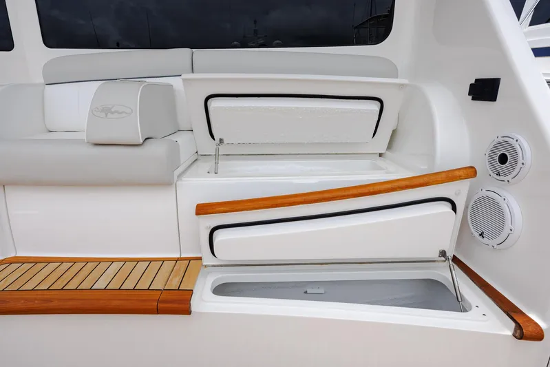 Insomnio Yacht Photos Pics Luxury seating and storage on 2022 Viking 48 Convertible yacht, featuring sleek design and wood accents.