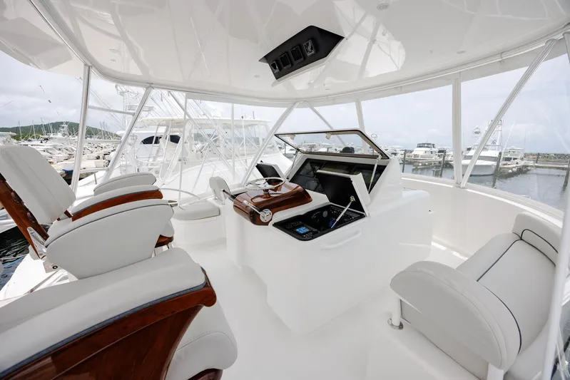 Insomnio Yacht Photos Pics Luxurious interior of 2022 Viking 48 Convertible yacht with modern helm and seating.