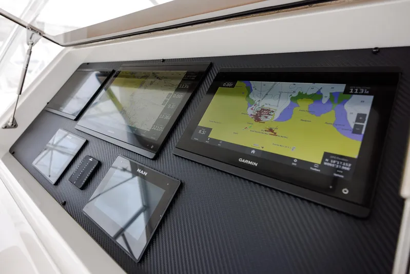 Insomnio Yacht Photos Pics Control panel of a 2022 Viking 48 Convertible yacht with navigation screens.