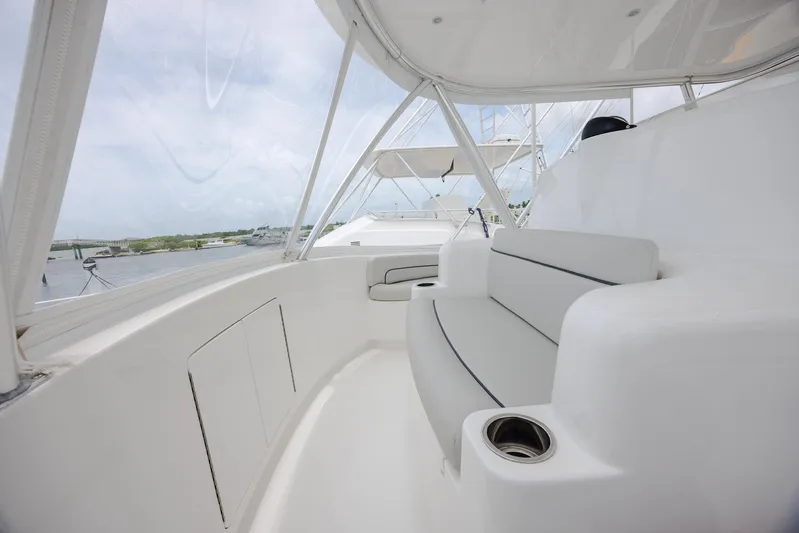 Insomnio Yacht Photos Pics Luxurious seating area on 2022 Viking 48 Convertible yacht, featuring sleek white design.