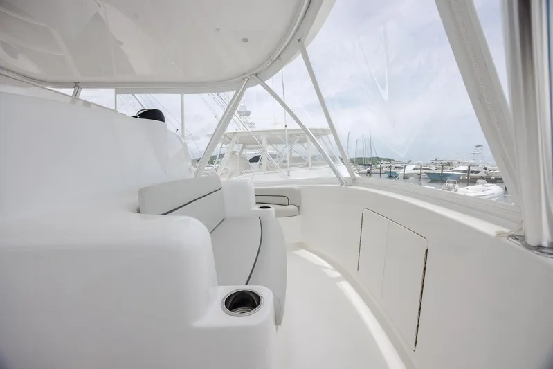 Insomnio Yacht Photos Pics 2022 Viking 48 Convertible yacht interior with sleek white seating and marina view.