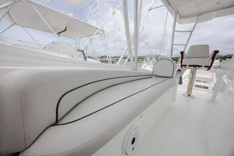 Insomnio Yacht Photos Pics 2022 Viking 48 Convertible yacht interior with white seating and helm chair.