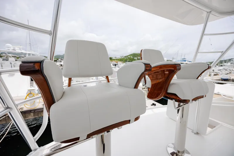 Insomnio Yacht Photos Pics Luxury seating on 2022 Viking 48 Convertible yacht, featuring elegant white and wood design.
