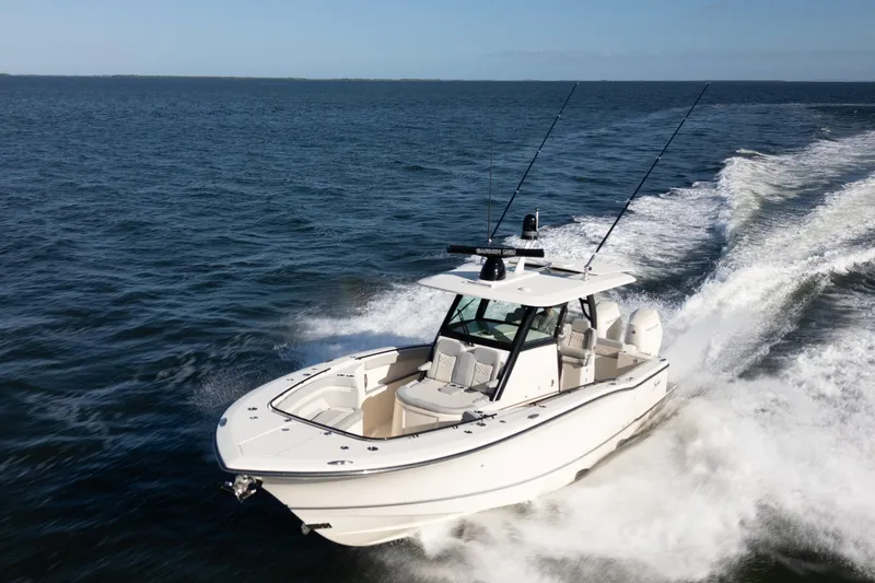 Natural 9 Yacht Photos Pics 2024 Scout 330 LXF boat cruising on open water, showcasing sleek design and performance.