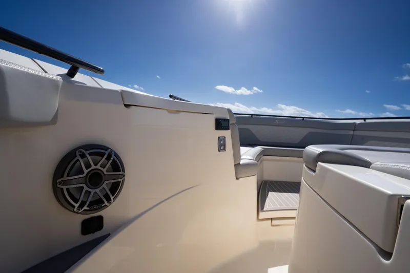 Natural 9 Yacht Photos Pics 2024 Scout 330 LXF boat interior with seating and speaker under clear blue sky.