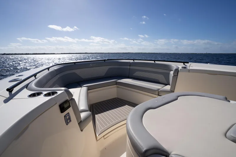 Natural 9 Yacht Photos Pics 2024 Scout 330 LXF boat interior with luxurious seating, ocean view, and clear sky.