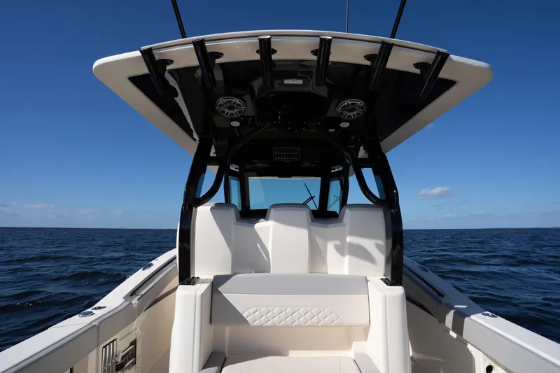 Natural 9 Yacht Photos Pics 2024 Scout 330 LXF boat interior with ocean backdrop under clear blue sky.