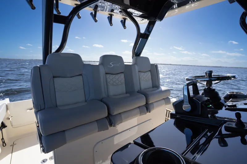 Natural 9 Yacht Photos Pics 2024 Scout 330 LXF boat interior with luxurious seating and steering console on open water.