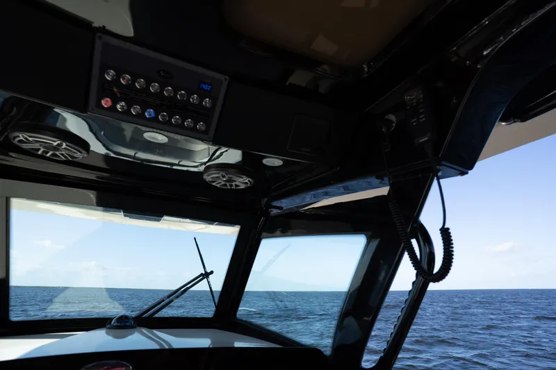 Natural 9 Yacht Photos Pics Interior view of 2024 Scout 330 LXF boat dashboard overlooking the ocean.