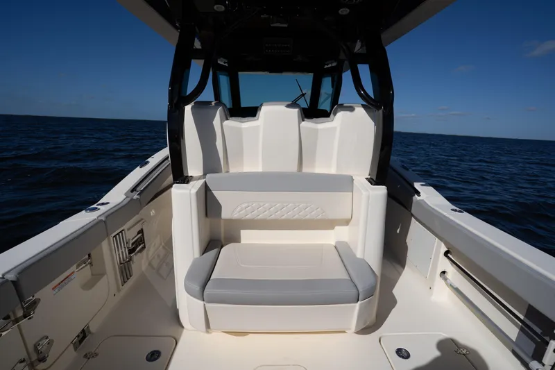 Natural 9 Yacht Photos Pics 2024 Scout 330 LXF boat interior with seating, on open water.