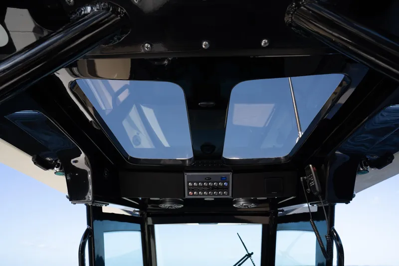 Natural 9 Yacht Photos Pics 2024 Scout 330 LXF boat interior with skylights and control panel.