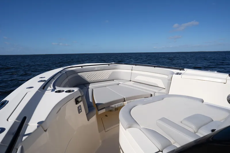 Natural 9 Yacht Photos Pics 2024 Scout 330 LXF boat interior with luxurious seating on open water.