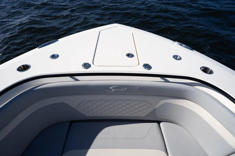 Natural 9 Yacht Photos Pics 2024 Scout 330 LXF boat bow with luxurious seating and ocean view.