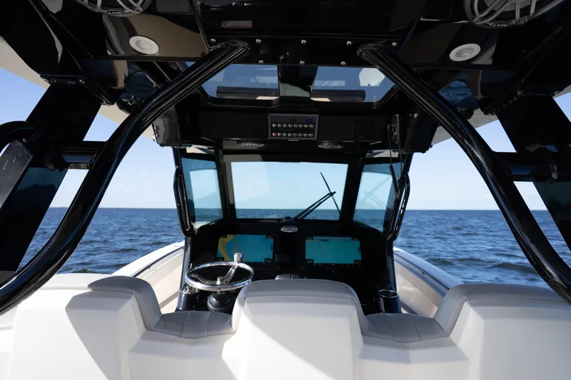 Natural 9 Yacht Photos Pics Interior view of 2024 Scout 330 LXF boat cockpit with ocean backdrop.