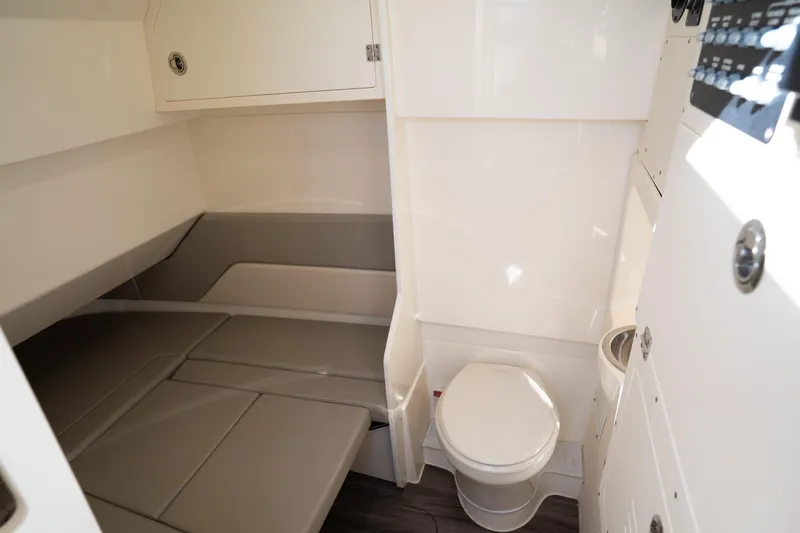 Natural 9 Yacht Photos Pics 2024 Scout 330 LXF cabin interior with bed and toilet, featuring modern design and amenities.