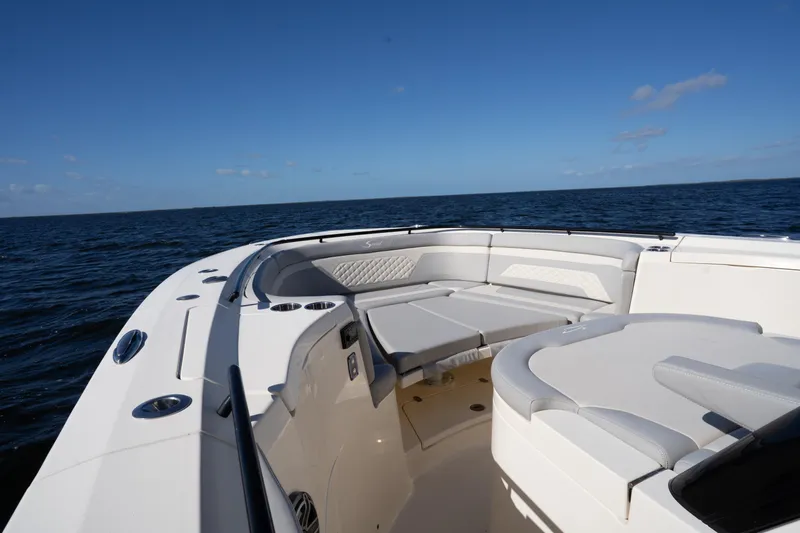Natural 9 Yacht Photos Pics 2024 Scout 330 LXF boat interior with luxurious seating on open water.