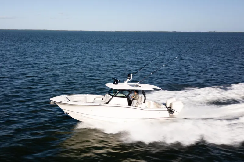 Natural 9 Yacht Photos Pics 2024 Scout 330 LXF boat cruising swiftly on open water.