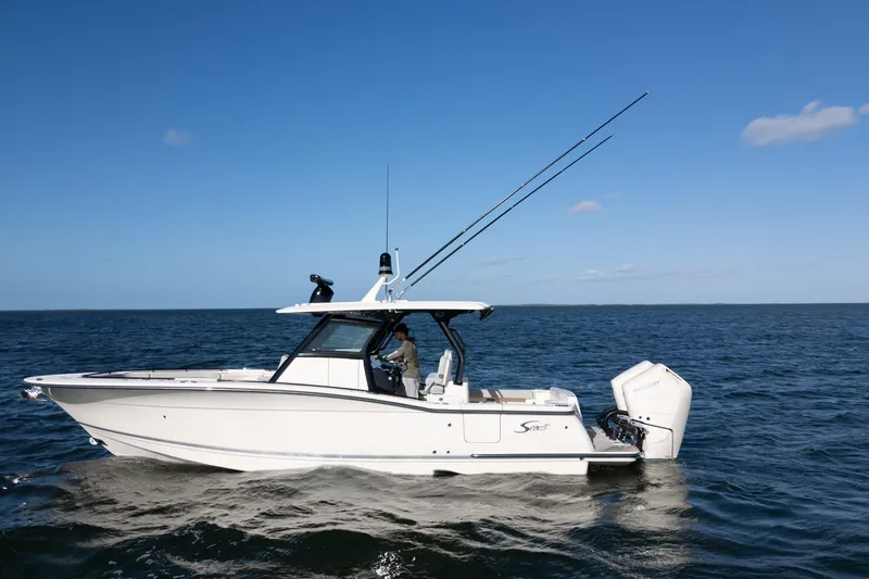 Natural 9 Yacht Photos Pics 2024 Scout 330 LXF boat cruising on open water under clear blue sky.