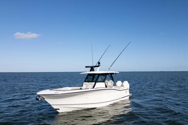 Natural 9 Yacht Photos Pics 2024 Scout 330 LXF boat on open water under clear blue sky.