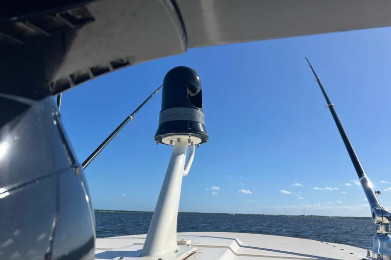 Natural 9 Yacht Photos Pics 2024 Scout 330 LXF boat with fishing rods and radar on open water.