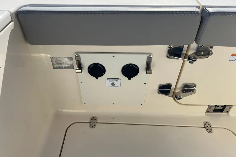 Natural 9 Yacht Photos Pics 2024 Scout 330 LXF boat interior with utility panel and storage compartment.