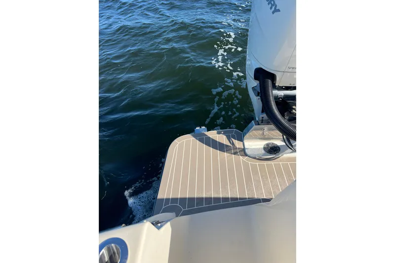 Natural 9 Yacht Photos Pics 2024 Scout 330 LXF boat deck with outboard motor on water.