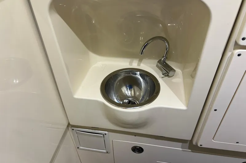 Natural 9 Yacht Photos Pics 2024 Scout 330 LXF boat interior sink with modern faucet design.