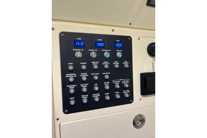 Natural 9 Yacht Photos Pics Control panel of 2024 Scout 330 LXF boat with various switches and digital displays.