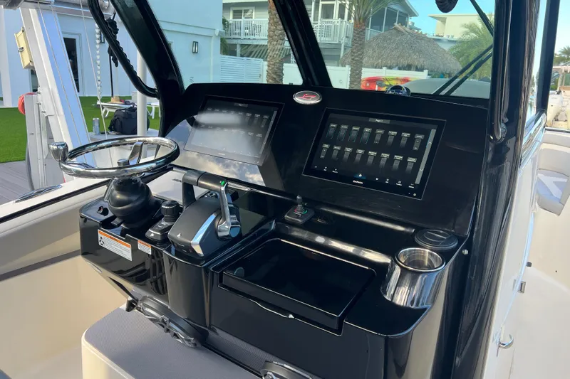 Natural 9 Yacht Photos Pics 2024 Scout 330 LXF boat dashboard with steering wheel and digital controls.
