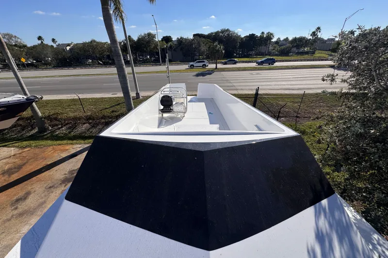  Yacht Photos Pics 2025 Don Smith Custom 55' boat on display near a highway, surrounded by trees.