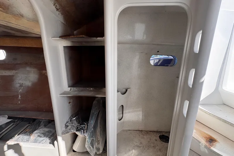  Yacht Photos Pics Interior of 2025 Don Smith Custom 55' boat, featuring storage shelves and small window.