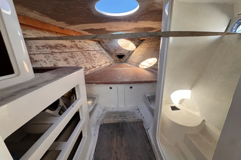  Yacht Photos Pics Interior of 2025 Don Smith Custom 55' boat, featuring unfinished cabin space with circular windows.