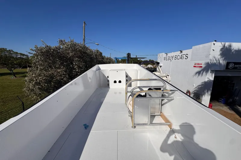  Yacht Photos Pics Rooftop view of 2025 Don Smith Custom 55' boat at Webly Boats dealership.