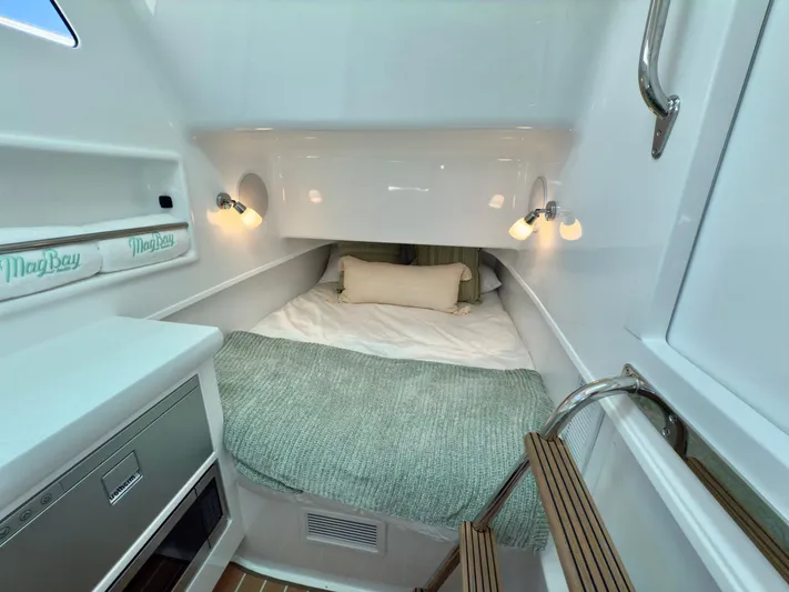  Yacht Photos Pics 2025 Mag Bay 38 CC cabin interior with cozy bed and modern lighting.