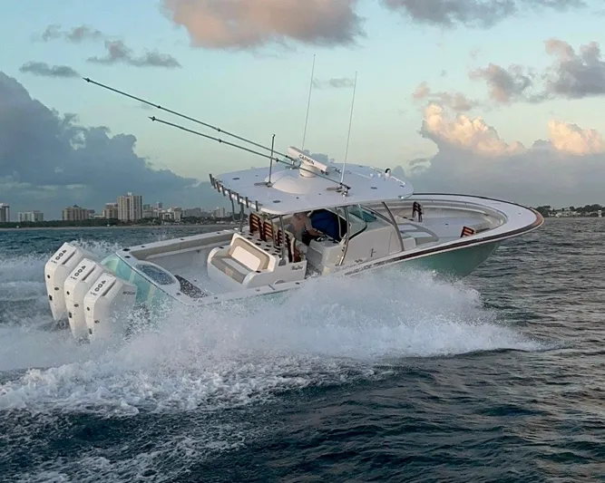  Yacht Photos Pics 2025 Mag Bay 38 CC boat cruising on open water at sunset.