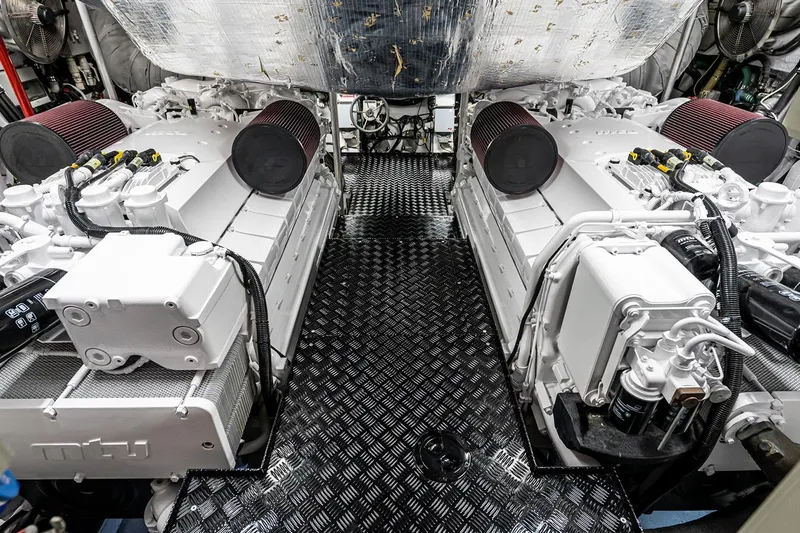 Norma Jean Yacht Photos Pics Engine room of a 2007 Sunseeker Predator 82 yacht, featuring dual engines and metallic flooring.