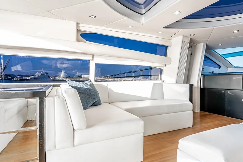 Norma Jean Yacht Photos Pics Luxurious interior of 2007 Sunseeker Predator 82 yacht with white seating and panoramic windows.